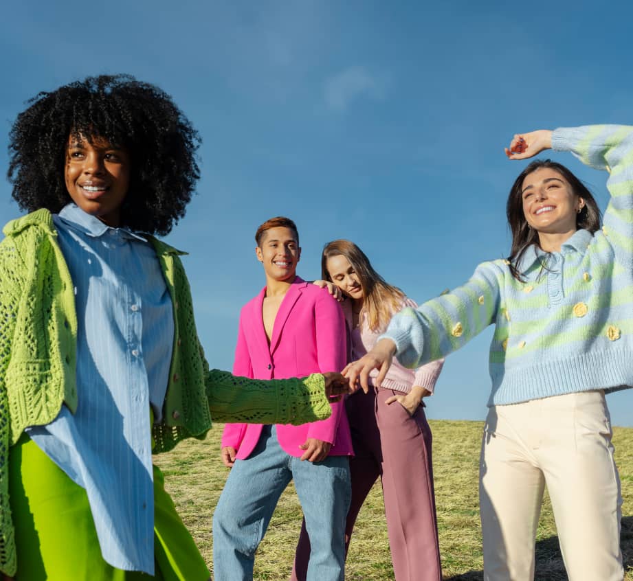 happy smiling friends in stylish clothes